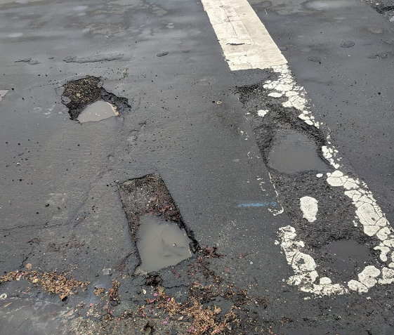 photo of deep street potholes